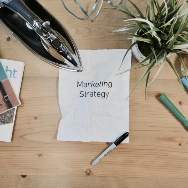 Paper saying "Marketing strategy" on a desk