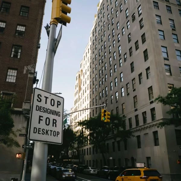 American city where a street sign says STOP Designing for Desktop
