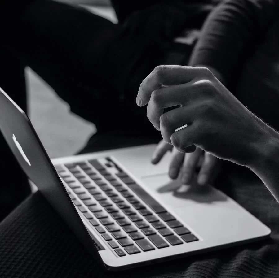 Man sitting in front of laptop looking for something