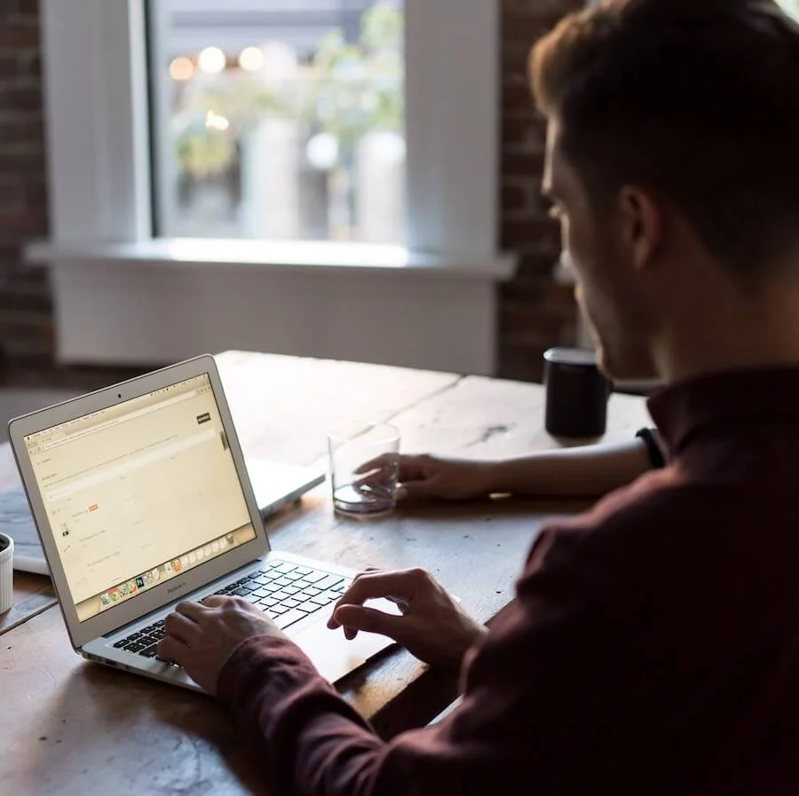 Man sitting in front of a laptop
