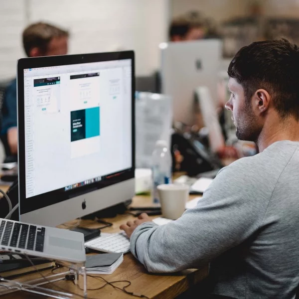 Man sitting in front of a laptop in an office