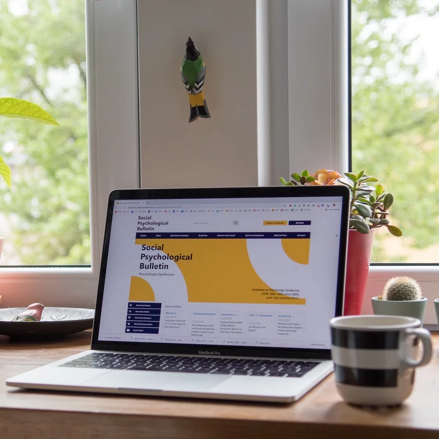 Open laptop and a cup on a desk