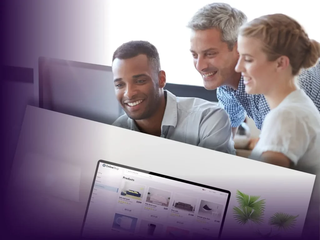 A group of three people, two men and one woman, are smiling and looking at a computer screen together. The man on the left is of African descent, the man in the middle has gray hair, and the woman has blonde hair styled in a braid. The lower part of the image features a partially visible computer screen displaying an online shop with various products.