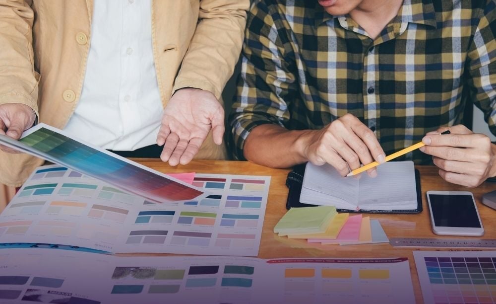 Team developing a new brand identity using color palettes and design guidelines